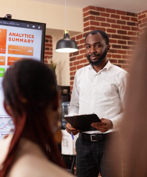 Businesspeople analyzing financial graph working at business presentation during startup company office. Diverse entrepreneurs brainstorming ideas for management project discussing partnership